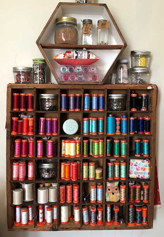 Said With Love Aurifil thread storage hanging on wall in old printers tray